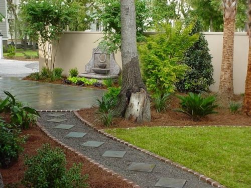 This backyard pathway has a clear destination - a small patio with a ...
