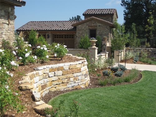 Stone retaining walls, a long driveway &amp; a walled motor court provide 