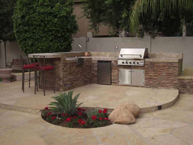This backyard cooking area has an Lshaped layout. Get ideas for your 